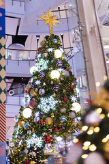 close up snowy Christmas tree with decoration ball and light bulb on festival market mall event...