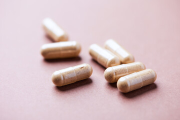 Korean Ginseng capsules. Concept for a healthy dietary supplementation. Bright paper background. Close up.
