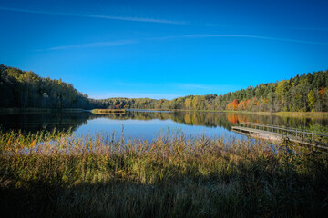 Fototapeta premium Tranquil Lake with Autumn Forest Reflection