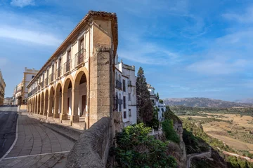 Historic buildings from the Puente Nuevo in the Ronda Tajo, in Malaga, Andalusia, Spain with daylight