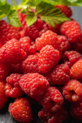 Ripe and juicy raspberry on the dark rustic background. Selective focus. Shallow depth of field.