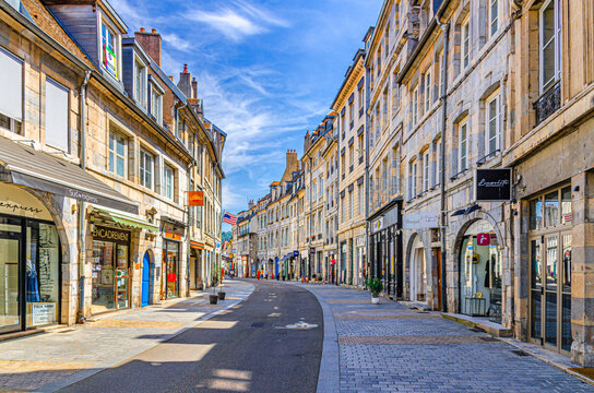 Besancon, France, July 10, 2024: people walking shopping street Rue Granges in Besancon city historic centre in sunny day, tourists stroll pedestrian street with stores and shops in Besan&ccedil;on old town