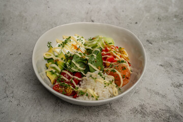 Bowl with lightly salted salmon, avocado, egg, rice, spinach and herbs