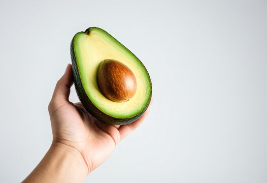 Avakado in hand on a white background