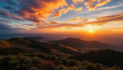 Obraz premium a view of a sunset over a mountain range with a valley below