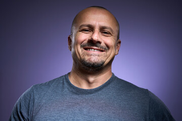Happy mature man on purple background