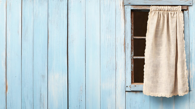 Cozy and rustic atmosphere created by a small window with a light beige curtain on a blue wooden wall