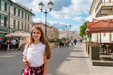 A tourist girl on a walking street in summer in Kazan, Tatarstan.