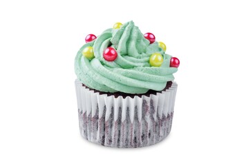 Chocolate cupcakes with green whipped cream topping in the form of Christmas tree for Christmas holidays on a white isolated background