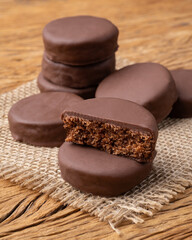 Brazilian Pao de Mel or chocolate covered honey cookies over a wooden table