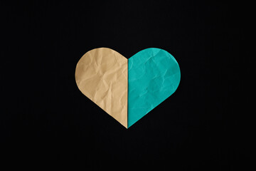 beige and teal Paper heart on black background