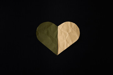 green & beige Paper heart on black background