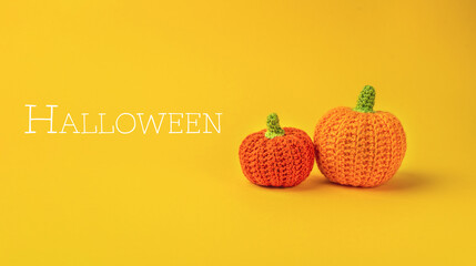 The image conveys a festive and playful mood, as the pumpkins are crocheted