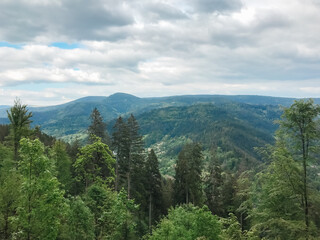 A mountain range with a cloudy sky in the background
