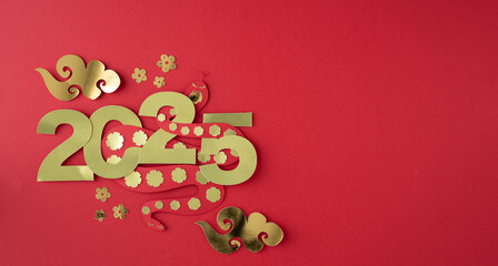 Chinese New Year, year of the snake 2025, snake passing through the numbers 0,2,5, figures cut out of paper.