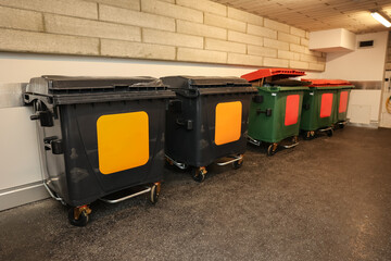 Plastic recycling containers in room