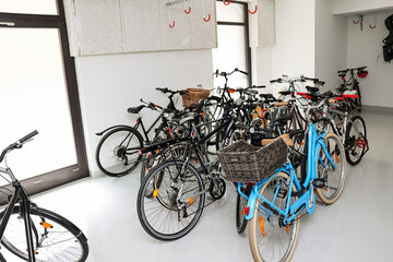 Modern bicycles parked in room
