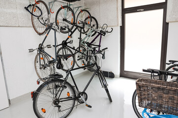 Modern bicycles hanging on light wall