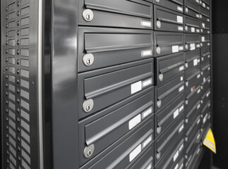 Black mailboxes in residential building, closeup