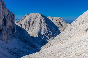 Sunny day in the Dolomites. Rocky mountain peaks of Dolomiti Alps in summer under the blue sky with...
