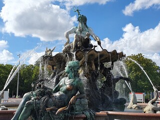 The landmark historic Neptunbrunnen, Neptune Fountain, on Alexanderplatz, Berlin, Germany, spews...