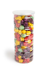 Plastic bottle with sweet colorful popcorn on white background