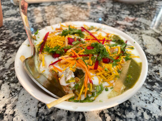 Indian Chaat with Curd, Sweet Sauce and many other ingredients served in a plate