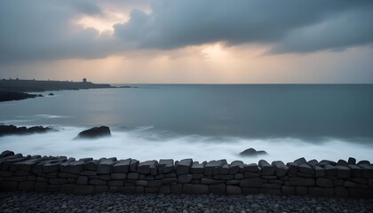 a rocky shoreline with a dark sky and waves