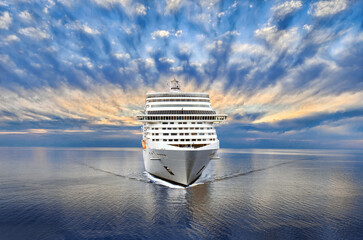 Luxury cruise ship sailing to port on sunset 