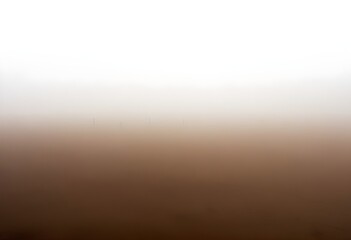 A vast, dusty landscape shrouded in a hazy, brown fog, with the horizon barely visible