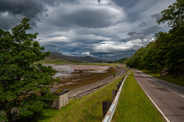 Abandoned Street To Applecross Pass With River Allt a'Chumhaing In Scotland, UK