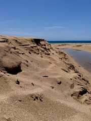 view of a sand dune with a small ravine on a beach in Guadeloupe in the Caribbean
