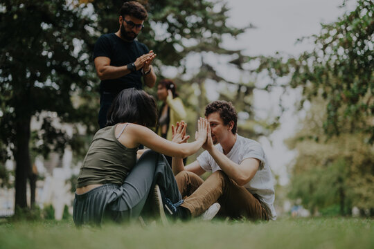 A group of students engaging in a fun outdoor sports class with their professor, enjoying hands-on physical activities amidst natural surroundings.