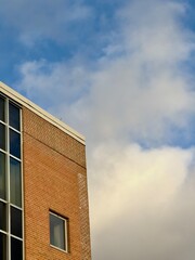 A brick building with blue sky and clouds