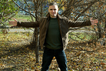 Dynamic pose amidst autumn leaves in a serene outdoor setting under bright sunlight