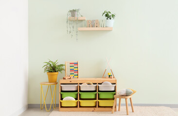 Interior of children's room with shelves, plants and toys