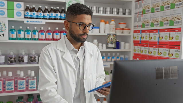 A young african american man dressed as a pharmacist works in an indoor pharmacy store setting.