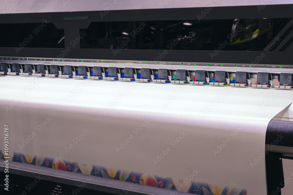 Poster a machine is printing a white sheet of paper with a colorful design. the machine has a lot of button