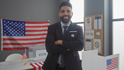Handsome hispanic man with a beard smiling in an american election room with crossed arms by the us...