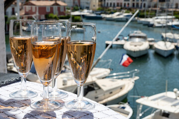 Summer party, French brut rose champagne sparkling wine in flute glasses in yacht harbour of Port Grimaud near Saint-Tropez, French Riviera vacation, Var, France