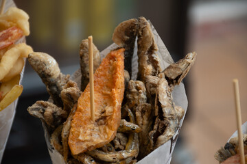 Italian streetfood, variety of catch of the day fish deep fried in paper cone