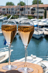 Summer party, French brut rose champagne sparkling wine in flute glasses in yacht harbour of Port Grimaud near Saint-Tropez, French Riviera vacation, Var, France
