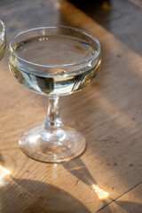 Sparkling wine, cava or champagne in two coupe glasses on wooden table, French Riviera is summer, France