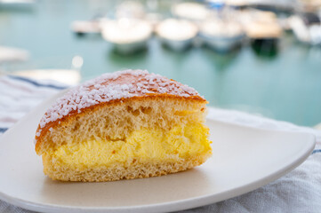 Cake of French Riviera, Tarte Tropezienne cake in yacht harbour of Port Grimaud, summer vacation in Provence, France