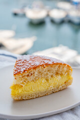 Cake of French Riviera, Tarte Tropezienne cake in yacht harbour of Port Grimaud, summer vacation in Provence, France