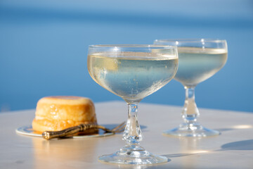 Cold sparkling wine, cava or champagne in two coupe glasses on table with blue sea water view, French Riviera is summer, France