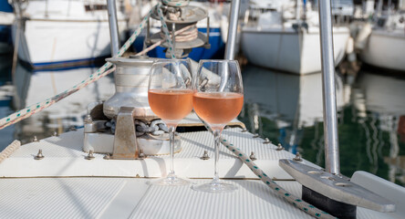 Party with rose wine on yacht boat anchored in port la Rague, Gulf of La Napoule, in Provence, two glasses of cold rose wine, French Riviera near Cannes, south of France