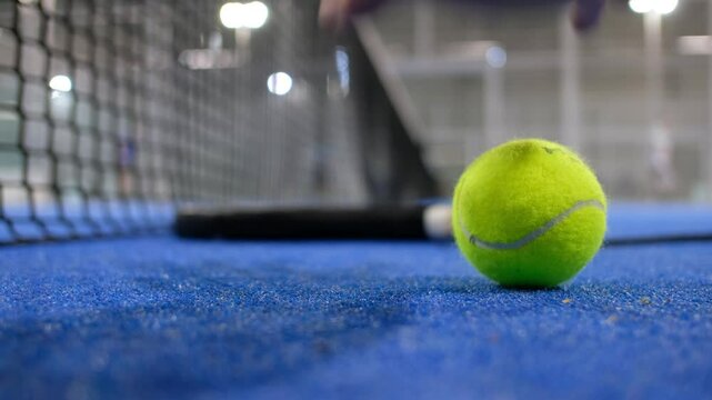 Paddle tennis rackets and balls in court