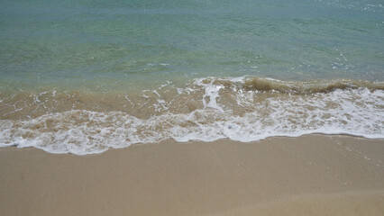 Sandy beach in pescoluse, salento, puglia, italy with clear turquoise water and gentle waves lapping the shore
