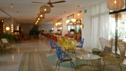 Blurry hotel lobby with defocused seating area, bokeh lighting, and blurred decor elements